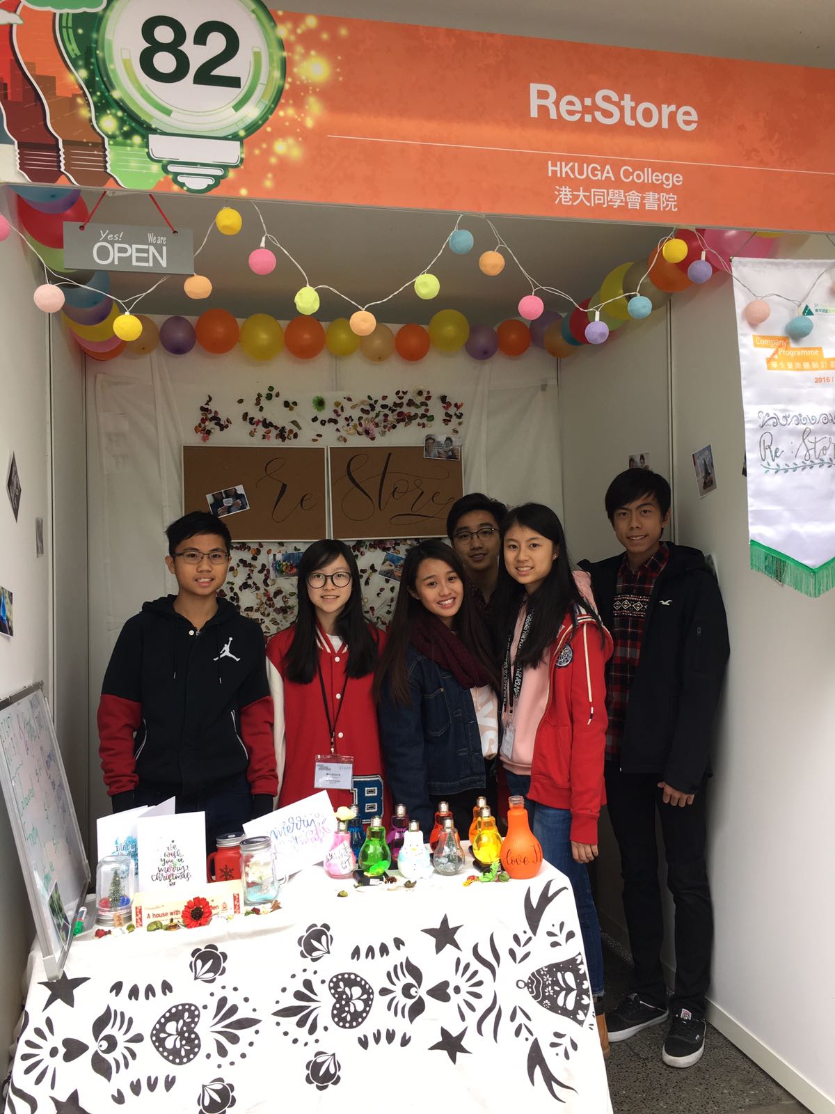 Group photo of participated students in front of the booth.
